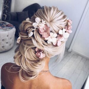 thick updo with flower pieces