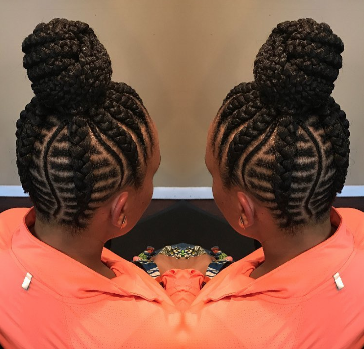 With fishbone braids and an elegant wrapped bun, this protective updo looks...