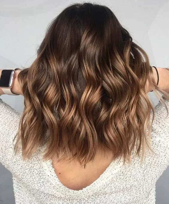 wavy medium brown hair with blonde highlights