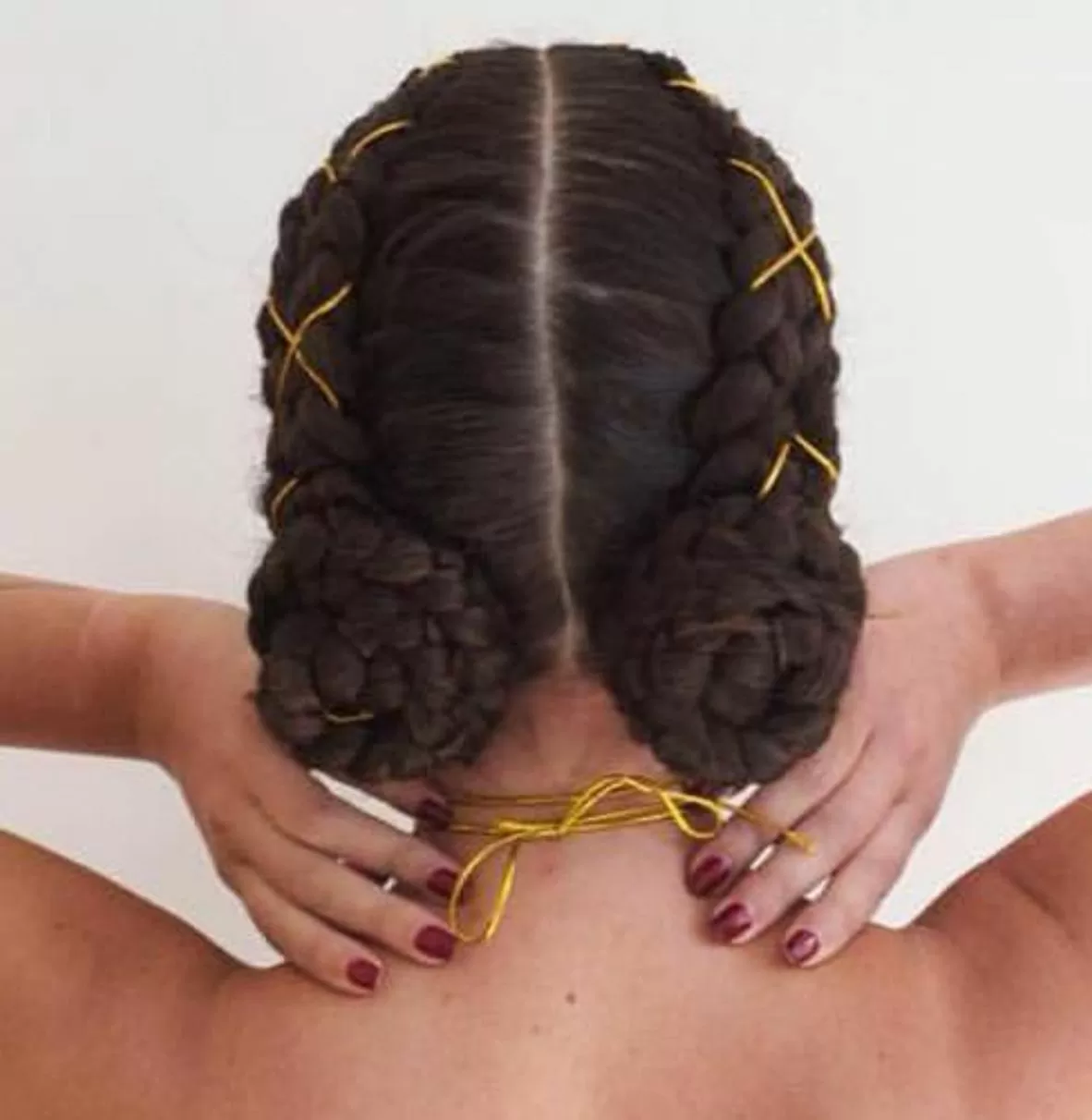 Low bun pigtail braids with weave